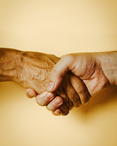 Two hands holding one another.